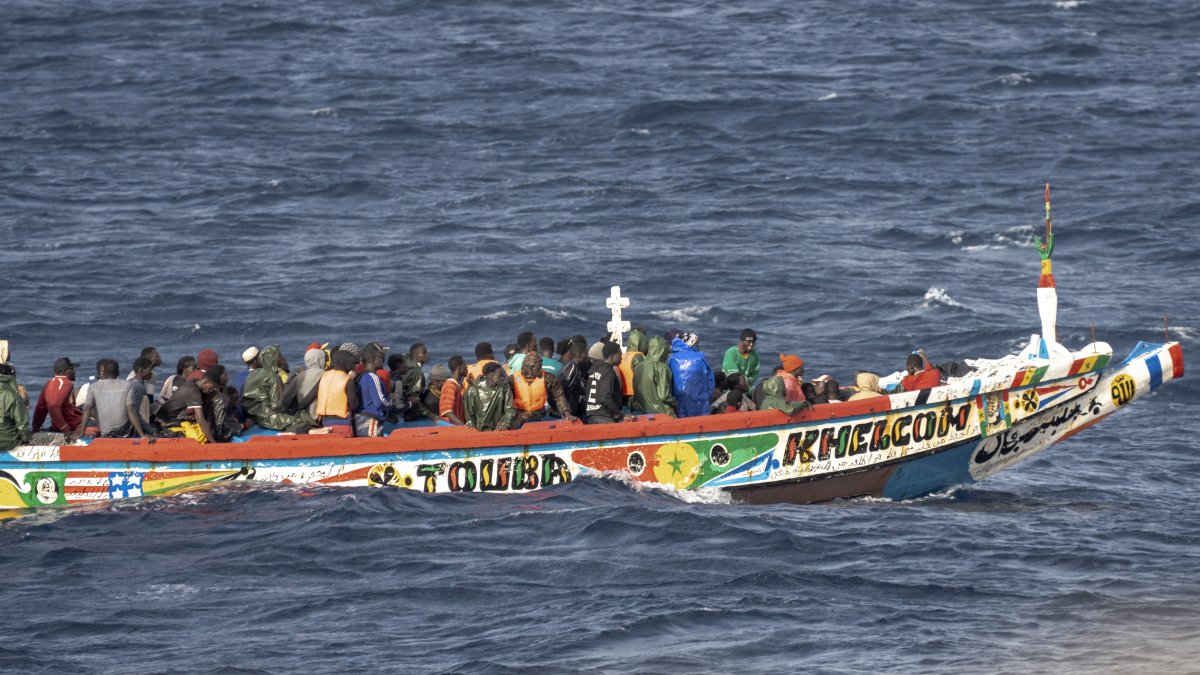 Migrants crowd a wooden boat as they sail to the port in La Restinga on the Canary island of El Hierro, Spain, Aug. 19, 2024. (AP Photo)