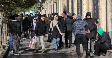 People walk past stores as the value of the Iranian Rial drops, in Tehran, Iran, Dec. 30, 2025. (Reuters Photo)