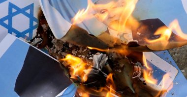 Somalis burn the Israel flag and an image depicting Israeli Prime Minister Benjamin Netanyahu during a demonstration, after Israel became the first country to formally recognize the self-declared Republic of Somaliland as an independent and sovereign state, Mogadishu, Somalia, Dec. 30, 2025. (Reuters Photo)