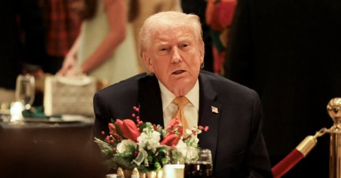 U.S. President Donald Trump takes part in a Christmas Eve dinner in the ballroom of his Mar-a-Lago club in Palm Beach, Florida, U.S., December 24, 2025. REUTERS/Jessica Koscielniak