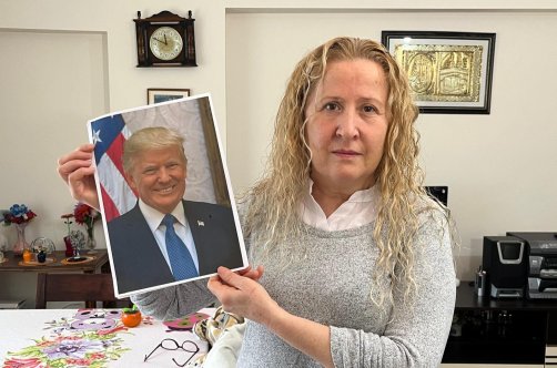 Necla Özmen poses with a photo of U.S. President Donald Trump during an interview with DHA at her home in the capital Ankara, Türkiye, Dec. 31, 2025. (DHA Photo)