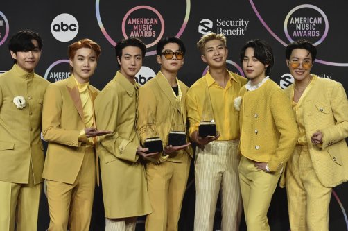 BTS poses in the press room with the awards for favorite pop duo or group, favorite pop song for "Butter," and artist of the year at the American Music Awards at Microsoft Theater in Los Angeles, U.S., Nov. 21, 2021. (AP Photo)