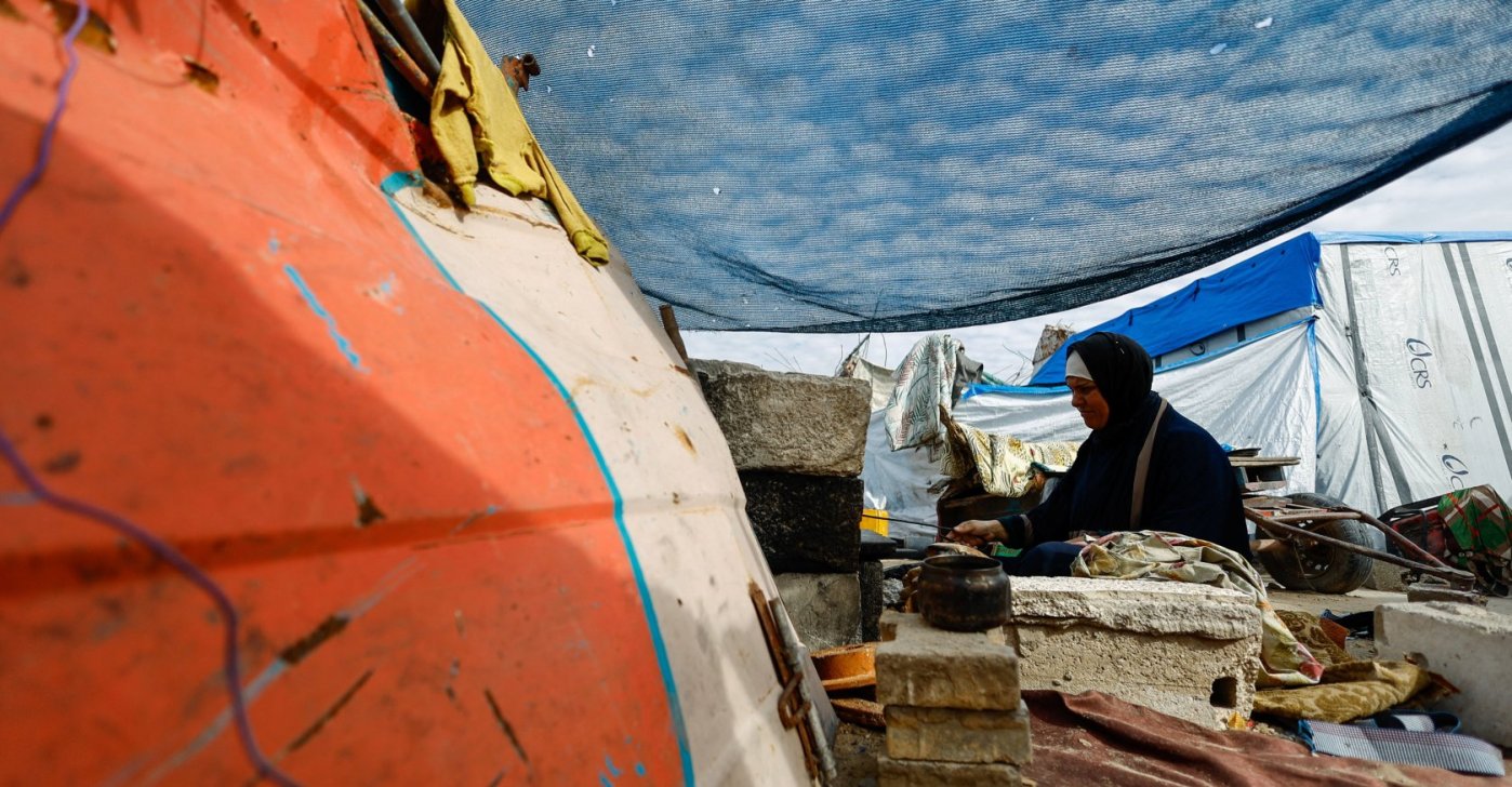 A displaced Palestinian woman cooks at a tent, on New Year's Eve in Jabalia, northern Gaza Strip, Dec. 31, 2025. (Reuters Photo)