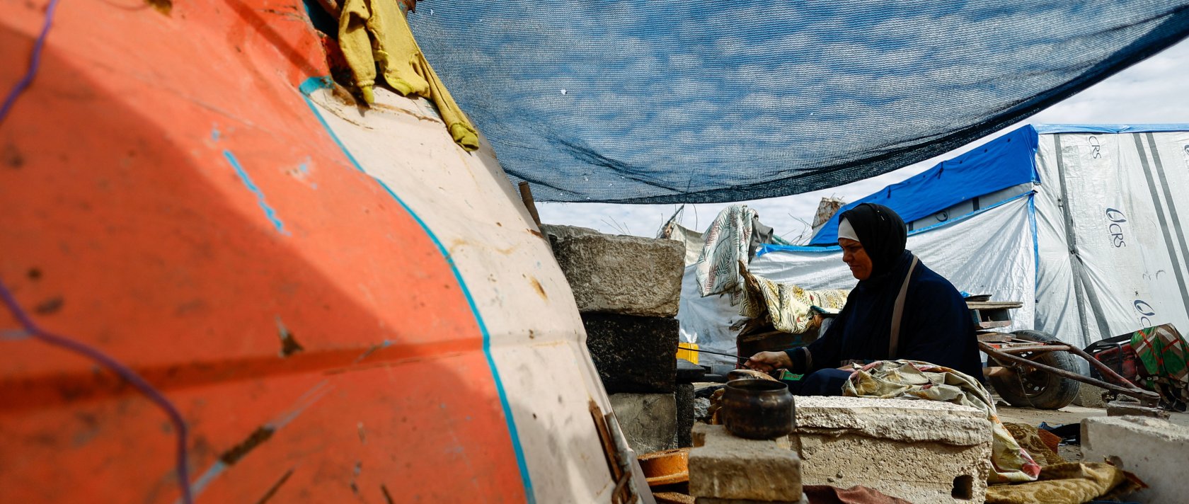 A displaced Palestinian woman cooks at a tent, on New Year's Eve in Jabalia, northern Gaza Strip, Dec. 31, 2025. (Reuters Photo)