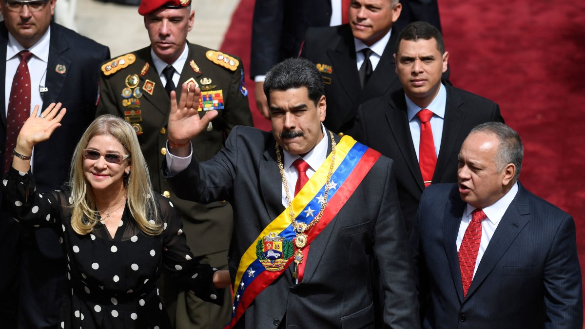 Venezuelan President Nicolas Maduro (C) and First Lady Cilia Flores (L) wave next to the president of the Constituent Assembly Diosdado Cabello, upon their arrival at the Constituent Assembly in Caracas, Venezuela, Jan. 14, 2020. (AFP Photo)