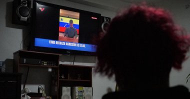 Venezuelans watch as Defense Minister Vladimir Padrino speaks on the television following U.S. attacks that captured President Nicolas Maduro and his wife, in Caracas, Venezuela, Jan. 3, 2026. (AA Photo)