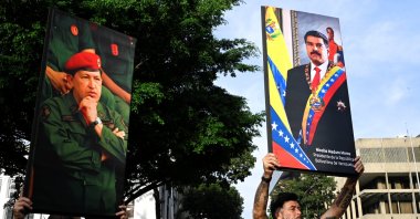 Government supporters hold photographs of Venezuela's late President Hugo Chavez and President Nicolas Maduro, after U.S. President Donald Trump said the U.S. has struck Venezuela and captured Maduro, in Caracas, Venezuela, Jan. 3, 2026. (Reuters Photo)