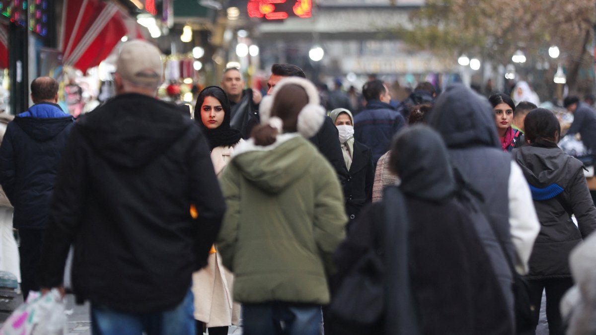 People walk on a street amid protests over the collapse of the currency's value in Tehran, Iran, Jan. 2, 2026. (Reuters Photo)