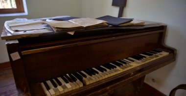 A piano once used by students is displayed inside the education museum housed, Düziçi, Türkiye, Jan. 4, 2026. (AA Photo)