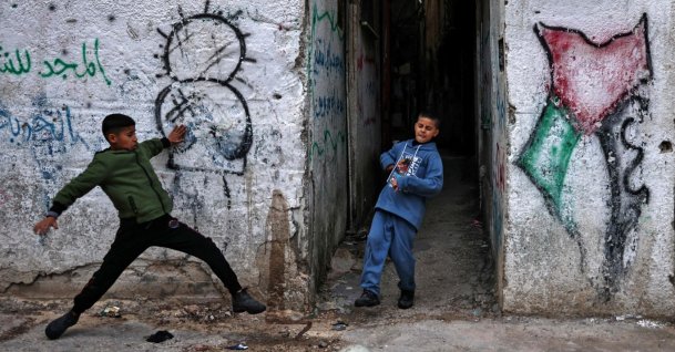 Boys play football at the Balata camp for Palestinian refugees, east of Nablus in the occupied West Bank, Dec. 30, 2025. (AFP Photo)