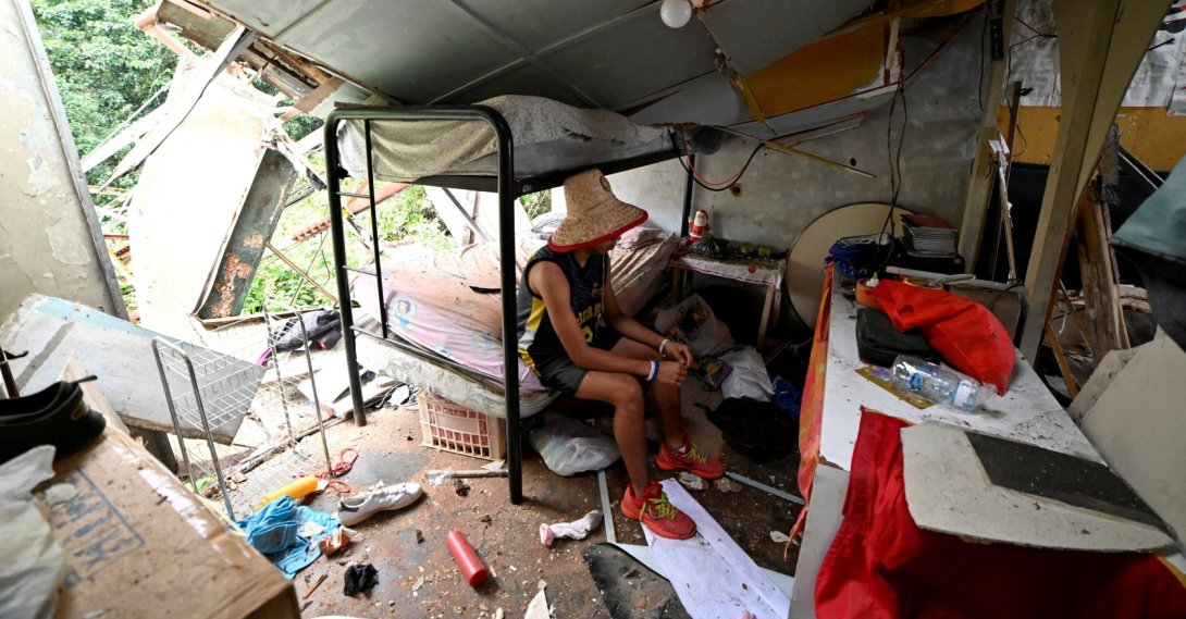 Maikel Linares, nephew of Carlos Bracho, salvages belongings from the rubble after a U.S. airstrike destroyed a TV and telephone tower that collapsed onto his home, killing a neighbor and injuring her daughter in the same attack, according to resident Carlos Bracho, in El Hatillo, on the outskirts of Caracas, Venezuela. Jan. 4, 2026. (Reuters Photo)