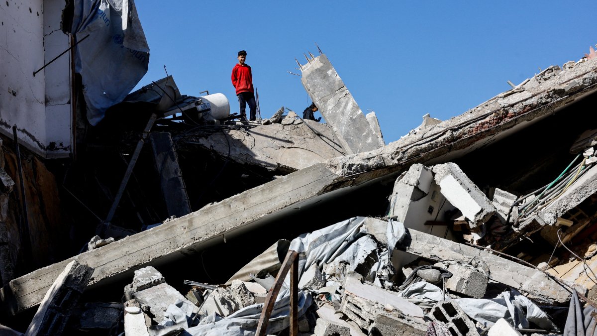 A Palestinian stands on rubble at the site of a collapsed house that was damaged during the war by an Israeli strike, in the central Gaza Strip, Palestine, Jan. 5, 2026. (Reuters Photo)