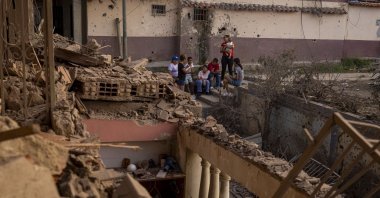 People look at a building damaged by an explosive device, in Catia La Mar, Venezuela, Jan. 4, 2026. (EPA Photo)