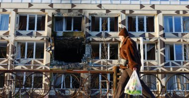 A resident walks past a building of a private hospital hit by Russian drone strikes, in Kyiv, Ukraine, Jan. 5, 2026. (Reuters Photo)