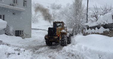 A tractor clears heavy snow from a road as snowfall continues in Şemdinli district, Hakkari, Türkiye, Jan. 5, 2026. (AA Photo)