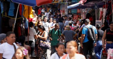 People walk through a market in the low-income Petare neighbourhood, Caracas, Venezuela, Nov. 16, 2024. (Reuters Photo)