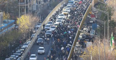 Protesters march on a bridge in Tehran, Iran, Dec. 29, 2025. (AP Photo)