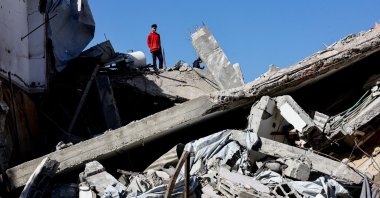 A Palestinian stands on rubble at the site of a collapsed house that was damaged during the war by an Israeli strike, in the central Gaza Strip, Palestine, Jan. 5, 2026. (Reuters Photo)