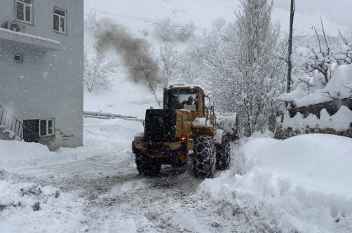 A tractor clears heavy snow from a road as snowfall continues in Şemdinli district, Hakkari, Türkiye, Jan. 5, 2026. (AA Photo)