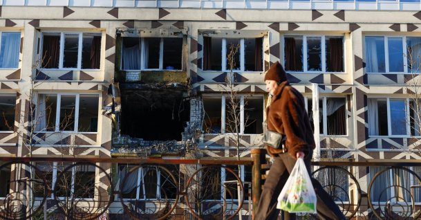 A resident walks past a building of a private hospital hit by Russian drone strikes, in Kyiv, Ukraine, Jan. 5, 2026. (Reuters Photo)