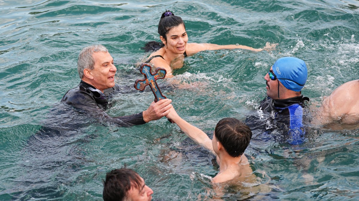 Orthodox Christians perform a traditional cross-diving ceremony at Moda Pier in Kadıköy, Istanbul, Türkiye, Jan. 6, 2025. (AA Photo)