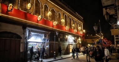Crowds gather in a street decorated with lights during New Year's celebrations, Damascus, Syria, Dec. 31, 2025. (EPA Photo)