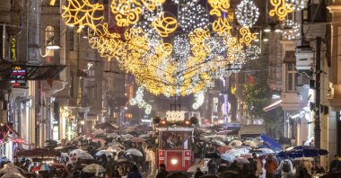 People walk along Istiklal Avenue decorated with New Year's lighting, Istanbul, Türkiye, Dec. 30, 2025. (Reuters Photo)