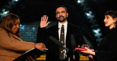 New York Mayor-elect Zohran Mamdani (C) places his hand on a Quran as he is sworn in by New York Attorney General Letitia James (L) and his wife Rama Duwaji looks on, New York, U.S., Jan. 1, 2026. (AFP Photo)