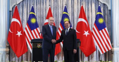 President Recep Tayyip Erdoğan and Malaysian Prime Minister Anwar Ibrahim (R) shake hands during their meeting, Putrajaya, Malaysia, Feb. 11, 2025. (AP Photo)