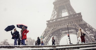People hold their umbrellas during a snowfall near the Eiffel Tower in Paris, France, Jan. 5, 2026. (EPA Photo)