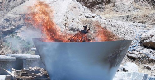 A pit filled with weapons is set on fire by the PKK during a ceremony, Sulaimaniyah, Iraq, July 11, 2025. (AFP Photo)