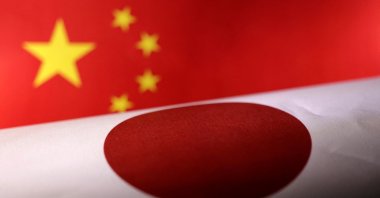 Printed Chinese and Japanese flags are seen in this illustration, July 21, 2022. (Reuters Photo)