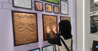 A tourist places her hands on BTS handprints at Line Friends Square in Myeongdong, Seoul, South Korea, Nov. 4, 2024. (Shutterstock Photo)