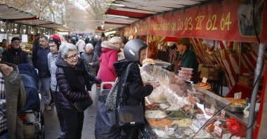 Customers buy groceries at the Daumesnil street food market, Paris, France, Dec. 16, 2025. (EPA Photo)