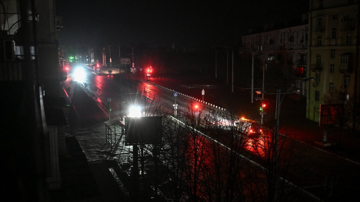 Cars move along a dark street during a power blackout in Zaporizhzhia, Ukraine, Jan. 7, 2026. (Reuters Photo)