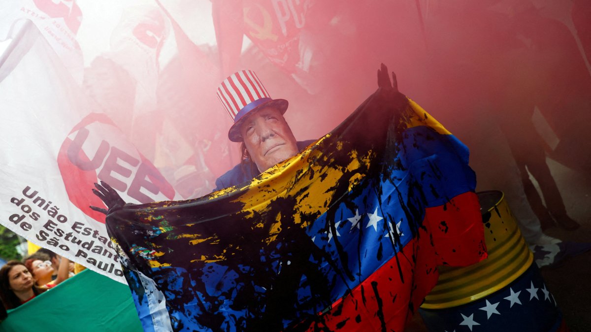 A man wears a mask depicting U.S. President Donald Trump during a protest against U.S. strikes on Venezuela and the capture of its President Nicolas Maduro, Sao Paulo, Brazil, Jan. 5, 2026. (Reuters Photo)