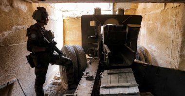 A U.N. peacekeeper stands by an artillery gun at a fortified position formerly held by Hezbollah in the Khraibeh Valley in el-Meri in south Lebanon, Aug. 27, 2025. (AFP Photo)