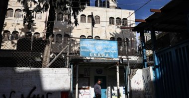 A man stands in front of a building of the United Nations Relief and Works Agency for Palestine Refugees (UNRWA) in the Askar camp for Palestinian refugees, east of Nablus in the Israeli-occupied West Bank, Dec. 31, 2025. (AFP File Photo)