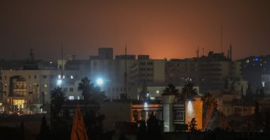 Smoke rises in the distance during clashes and shelling in the Sheikh Maqsoud and Ashrafiyah neighborhoods of Aleppo, northern Syria, Jan. 8, 2026. (EPA Photo)