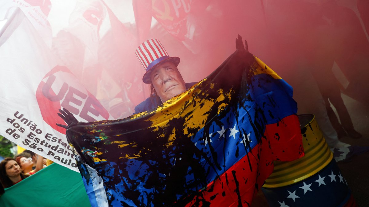 A man wears a mask depicting U.S. President Donald Trump during a protest against U.S. strikes on Venezuela and the capture of its President Nicolas Maduro, Sao Paulo, Brazil, Jan. 5, 2026. (Reuters Photo)