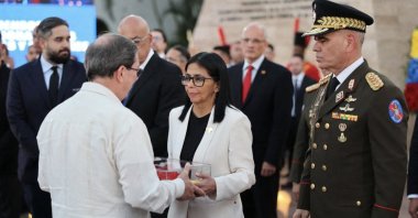 Venezuela's interim President Delcy Rodriguez (C) and Venezuelan Defense Minister Vladimir Padrino (R) greeting members of Cuban officials during a ceremony for the soldiers killed during the capture of ousted President Nicolas Maduro and his wife, Cilia Flores, by the US forces, Caracas, Venezuela, Jan. 8, 2026. (AFP Photo)