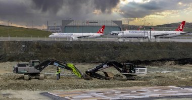 Excavators are seen at Istanbul Airport with Turkish Airlines aircraft in the background, Istanbul, Türkiye, Jan. 8, 2026. (IHA Photo)