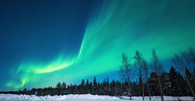 Green aurora borealis shines in the night sky in Finland. (Getty Images Photo)