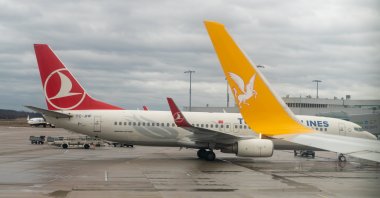 Turkish Airlines and Pegasus Airlines aircraft wait at a terminal at Istanbul Airport, Istanbul, Türkiye, April 2019. (Shutterstock Photo)