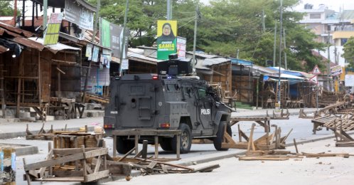 A Tanzanian police vehicle drives along a road barricaded by demonstrators during violent protests that marred the election following the disqualification of the two leading opposition candidates, Dar es Salaam, Tanzania, Oct. 29, 2025. (Reuters Photo)