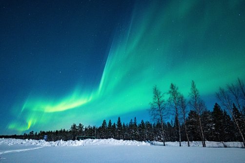 Green aurora borealis shines in the night sky in Finland. (Getty Images Photo)