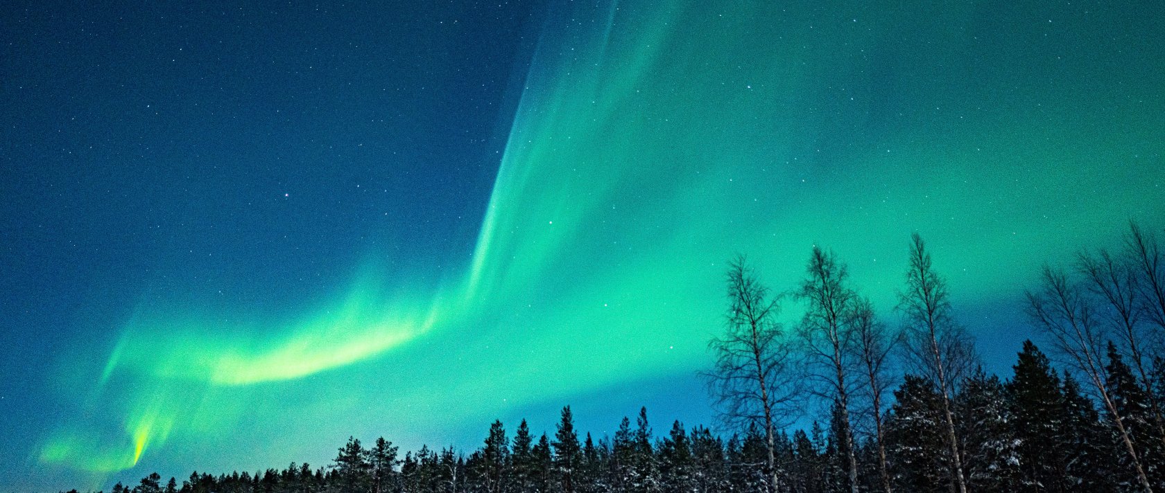 Green aurora borealis shines in the night sky in Finland. (Getty Images Photo)