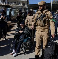 A man is assisted as he evacuates from Sheikh Maksoud neighbourhood following the collapse of an agreement between the Syrian government and the PKK/YPG terrorists, in Aleppo, Syria, Jan. 10, 2026. (Reuters Photo)