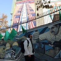 An Iranian man walks next to an anti-U.S. and Israeli billboard, Tehran, Iran, Jan. 4, 2026. (EPA Photo)