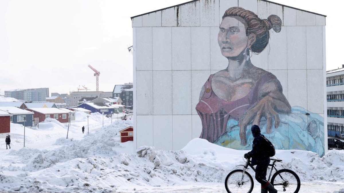 A man passes a building with social housing with an Inuit mural in Nuuk, Greenland, March 27, 2025. (Reuters Photo)